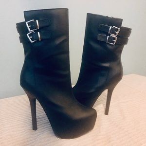 Tezra by Scene (SHOEDAZZLE) Black platform boots.